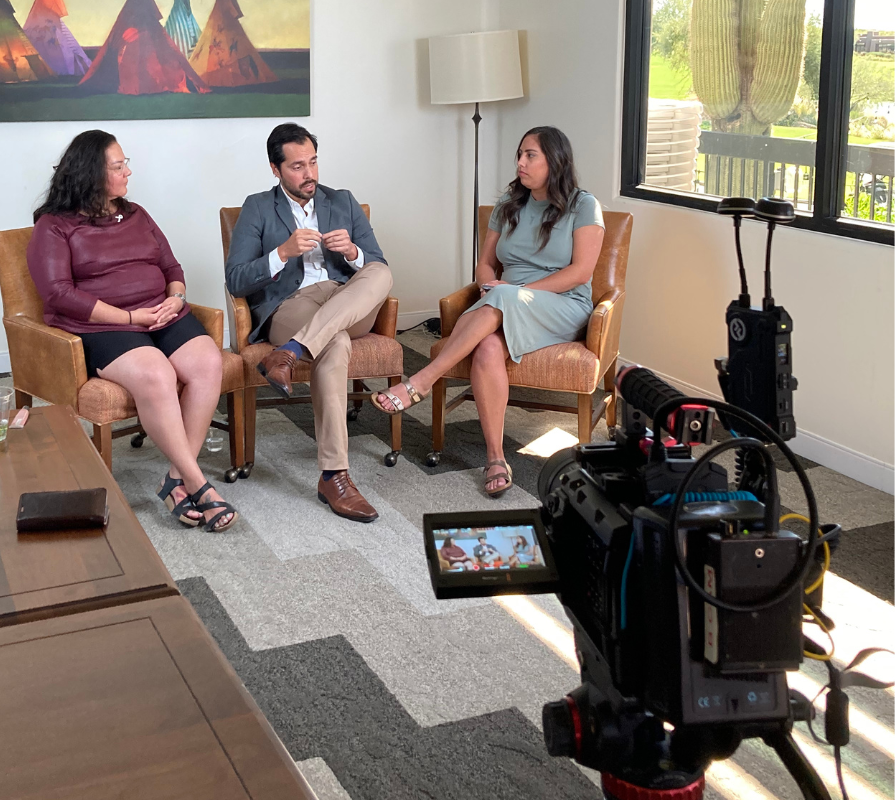 A doctor, a woman living with lung cancer and the interviewer creating an awareness video in Spanish.