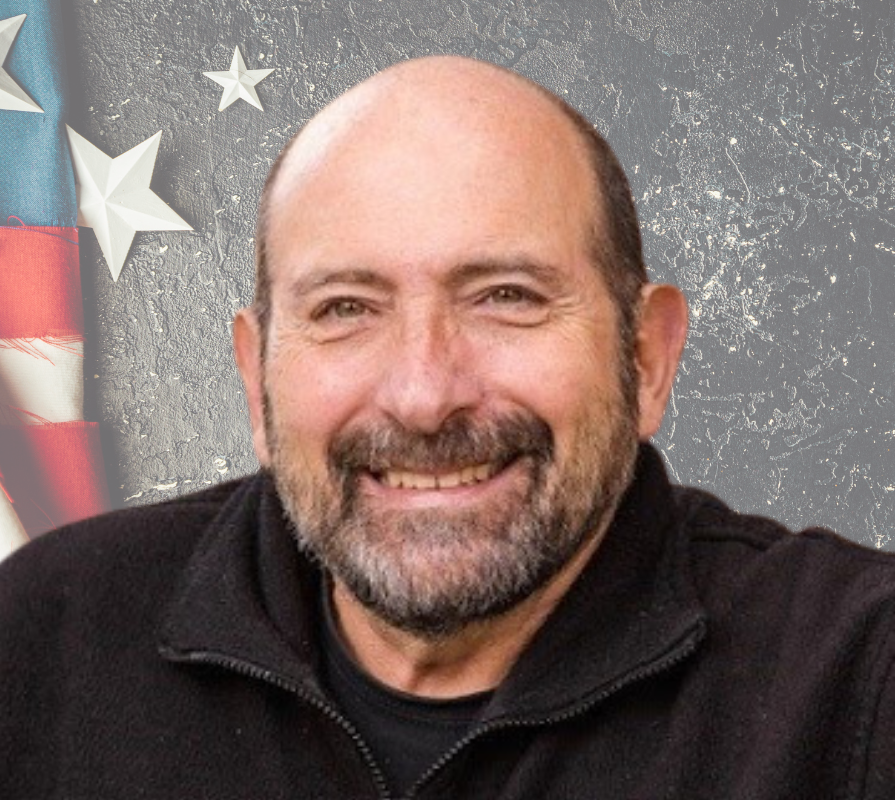 Jim Pantela with a patriotic background of stars and stripes