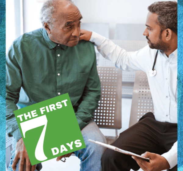 A doctor resting his hand on the shoulder of a senior man.