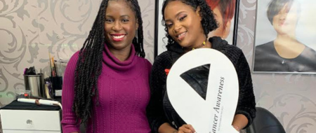 Voice of Hope Dr Barnard with her hairstylist holding a white lung cancer awareness ribbon